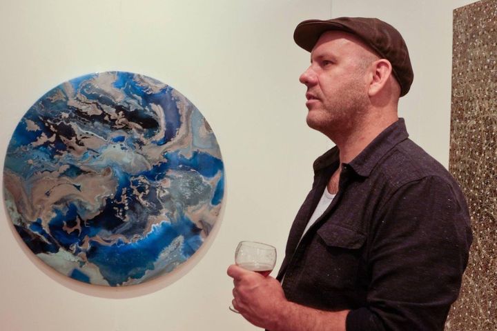 Adrian Pritchard holding a wineglass.