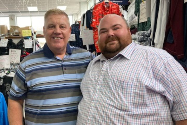 Two men standing side by side.