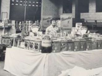 Old black and white photo of two stallholders inside Fleetwood Market.