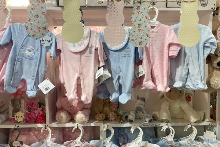 Row of baby clothes in blue and pink
