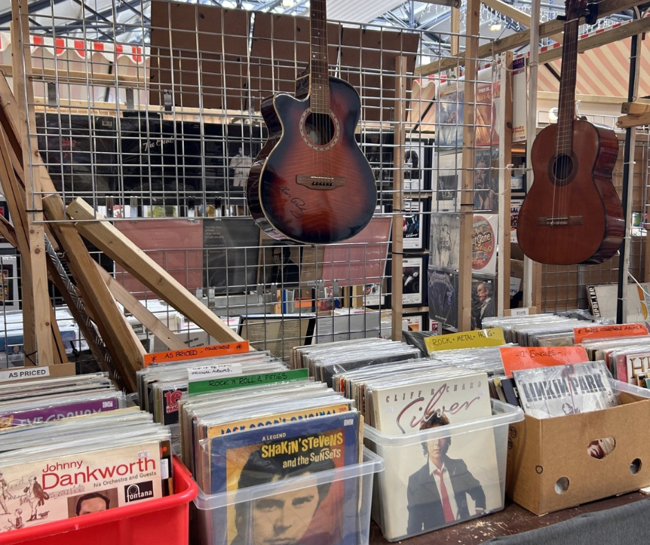 Records and guitar are on a market stall